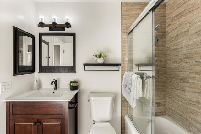 full bathroom with vanity, toilet, and combined bath / shower with glass door