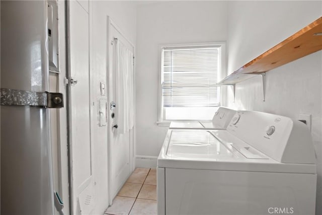 washroom featuring separate washer and dryer and light tile patterned floors