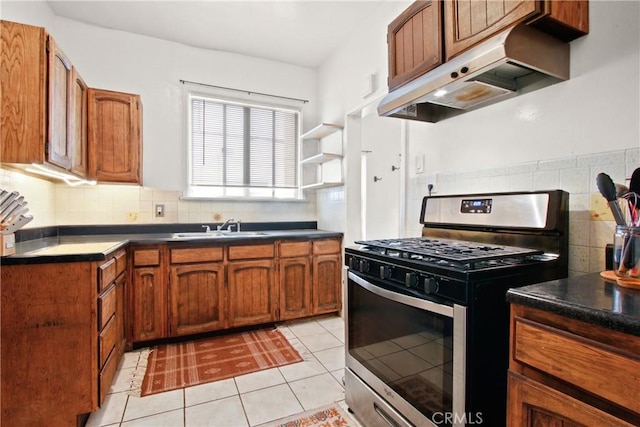 kitchen with tasteful backsplash, sink, light tile patterned flooring, and gas stove