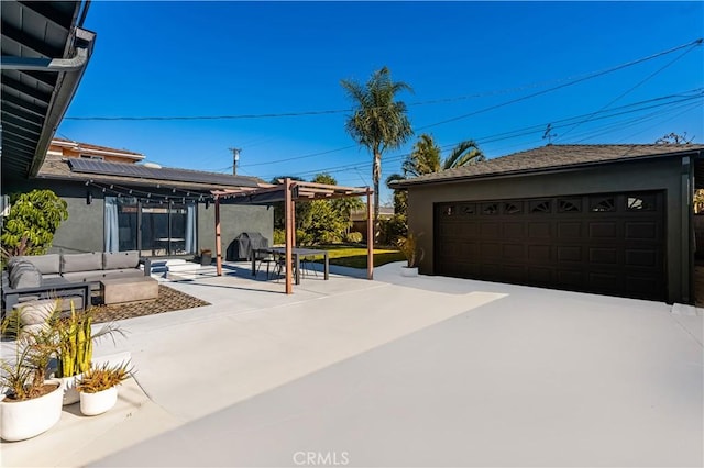 view of patio / terrace with outdoor lounge area, grilling area, and a garage