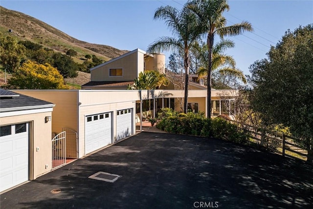 view of front of property with a mountain view and a garage