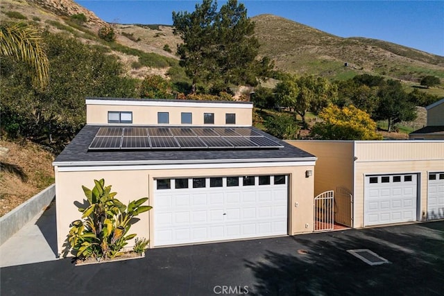 garage with a mountain view and solar panels