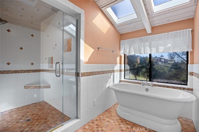 bathroom with wood ceiling, separate shower and tub, vaulted ceiling with skylight, tile walls, and tile patterned floors