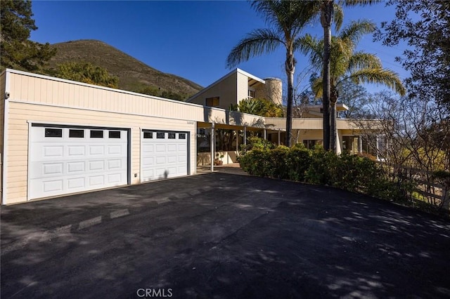 view of front facade featuring a mountain view and a garage