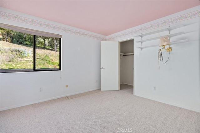 unfurnished bedroom featuring carpet floors and a closet