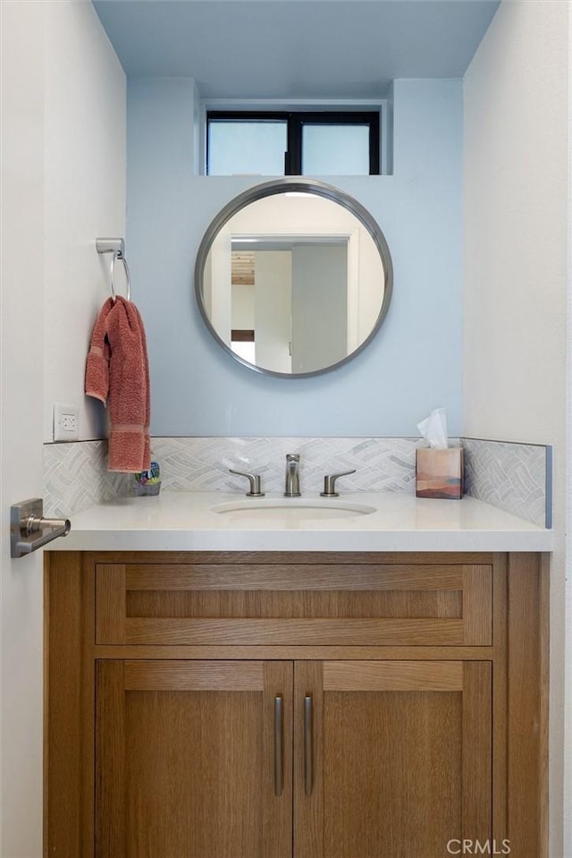 bathroom with tasteful backsplash and vanity