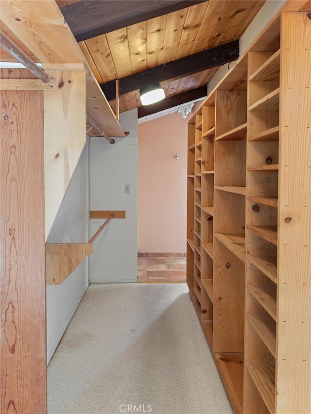 spacious closet featuring beamed ceiling