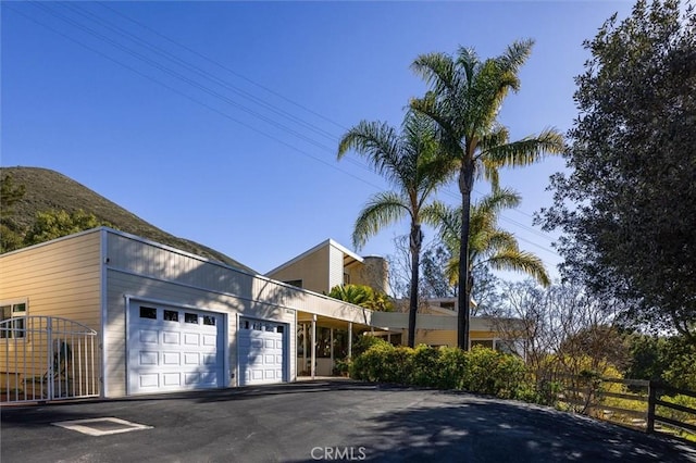 view of front of home featuring a mountain view and a garage