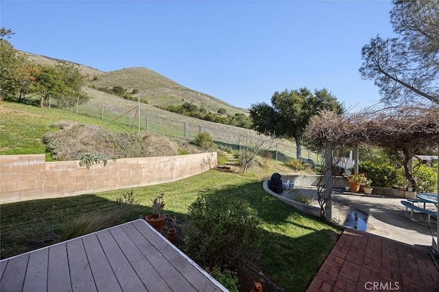 view of yard featuring a mountain view and a patio