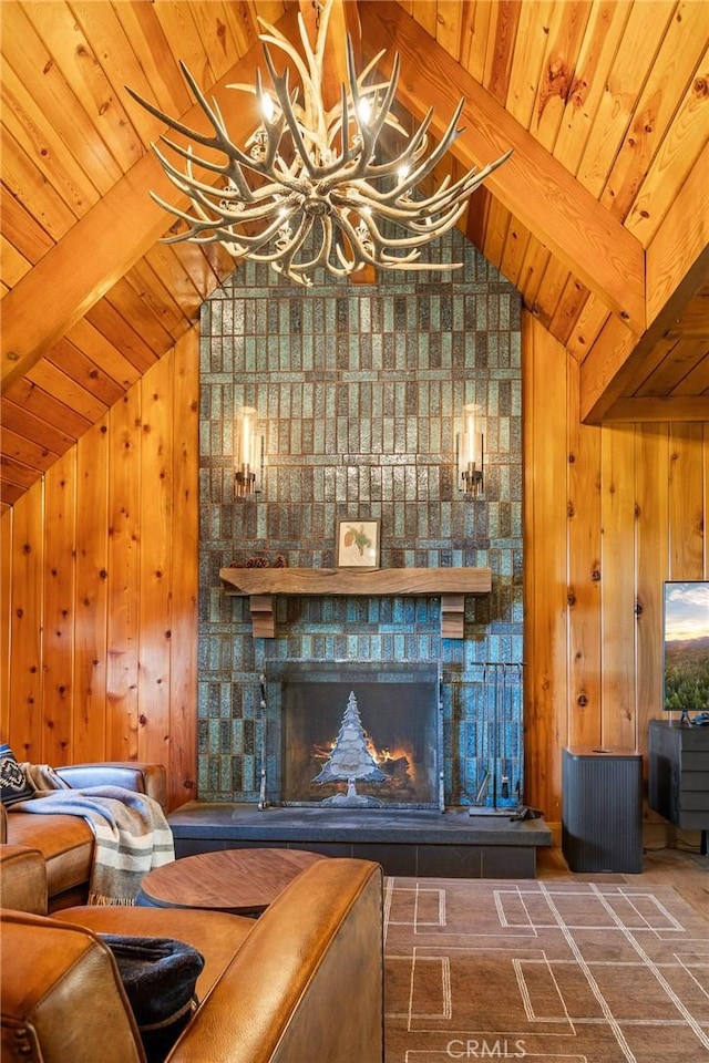 unfurnished living room featuring an inviting chandelier, a fireplace, vaulted ceiling with beams, and wooden walls