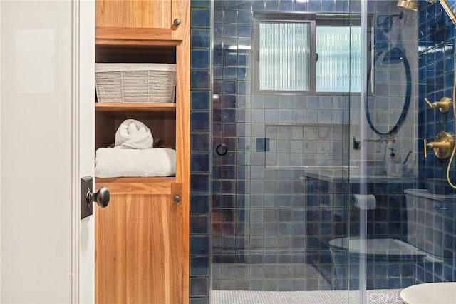 bathroom featuring toilet and a shower with shower door