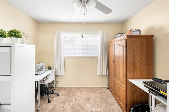 carpeted home office with ceiling fan