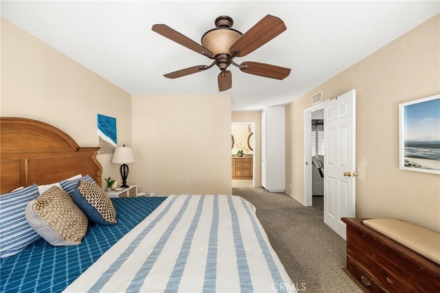 bedroom with ensuite bathroom, carpet, and ceiling fan