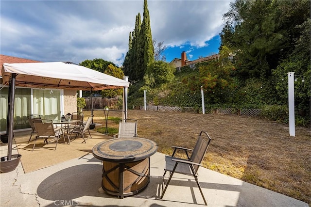 view of patio with a gazebo and a fire pit