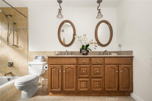 full bathroom featuring tiled shower / bath, toilet, tile patterned floors, and vanity