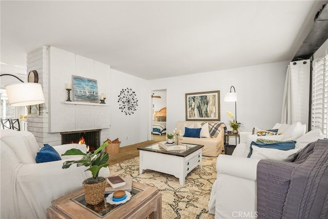 living room with a brick fireplace