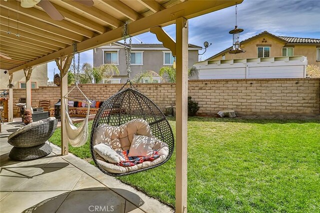 view of yard featuring ceiling fan and a patio