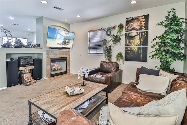 living room with a fireplace and carpet floors