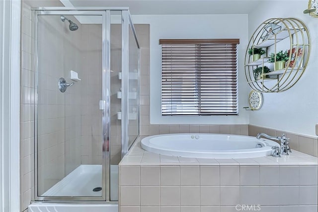 bathroom featuring separate shower and tub