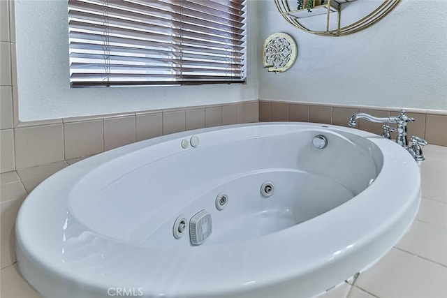 bathroom with a relaxing tiled tub