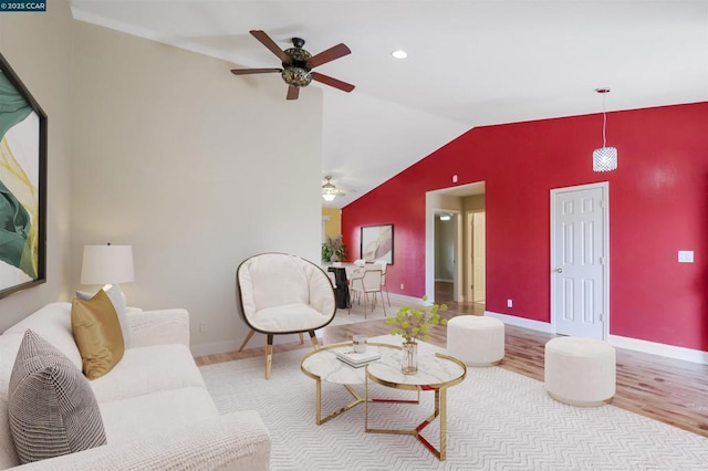 living room featuring light wood-type flooring, ceiling fan, and lofted ceiling