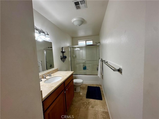 full bathroom with vanity, combined bath / shower with glass door, tile patterned floors, and toilet