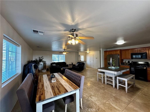 dining area featuring a healthy amount of sunlight and ceiling fan