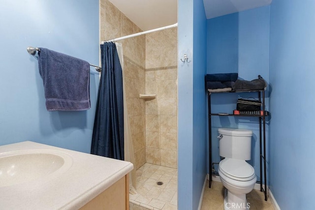 bathroom featuring toilet, vanity, and a shower with curtain