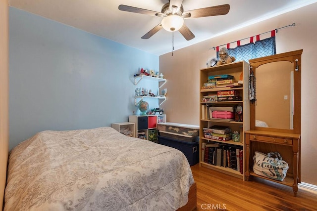 bedroom with ceiling fan and hardwood / wood-style flooring