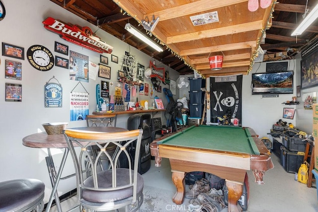 rec room featuring pool table, indoor bar, and concrete flooring