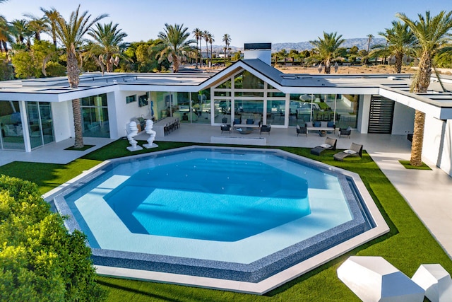 view of swimming pool with a patio area and a lawn