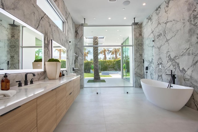 bathroom featuring plus walk in shower, tile walls, floor to ceiling windows, and vanity