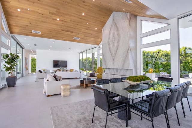 dining room with wooden ceiling and a high ceiling