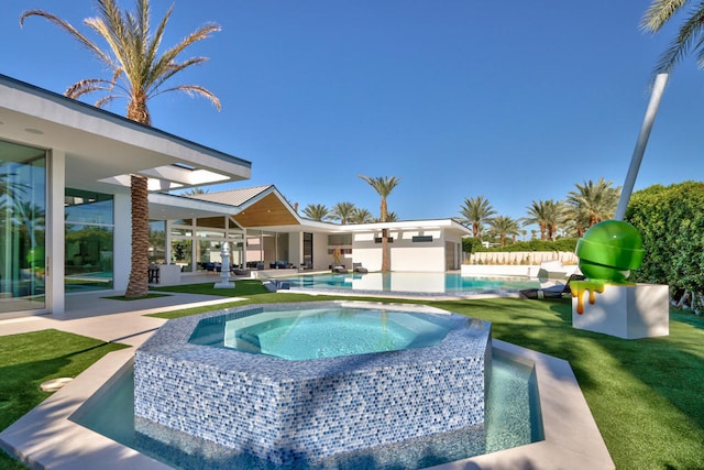 view of pool featuring a patio, a yard, and an in ground hot tub