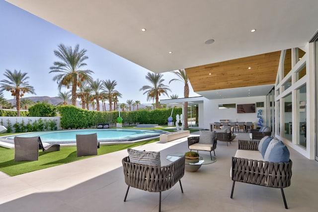 view of swimming pool featuring an outdoor living space and a patio area