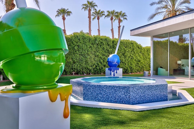 view of swimming pool with an in ground hot tub