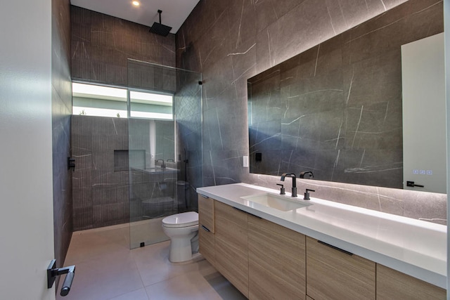 bathroom with tile walls, tile patterned floors, walk in shower, and toilet