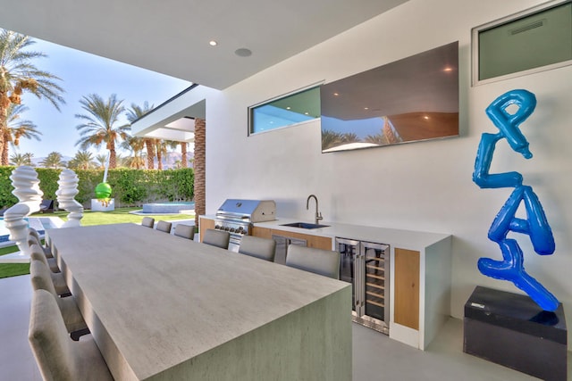 view of patio / terrace featuring grilling area, sink, area for grilling, and wine cooler