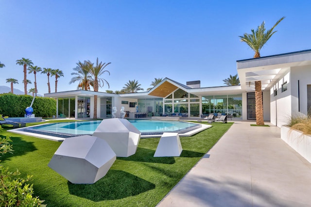 view of pool featuring a lawn and a patio area