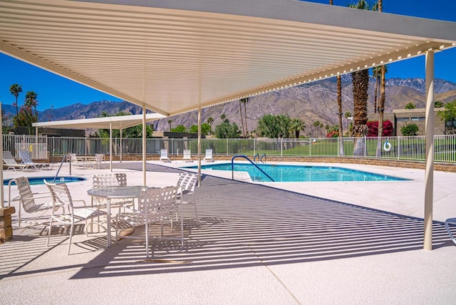 view of pool featuring a mountain view and a patio