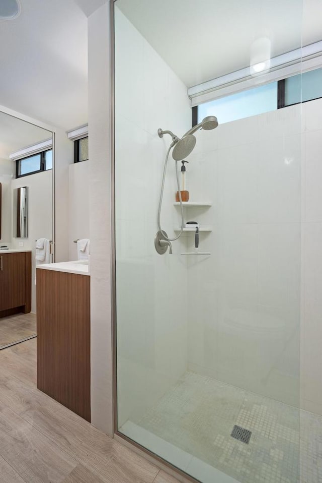 bathroom featuring a tile shower and vanity