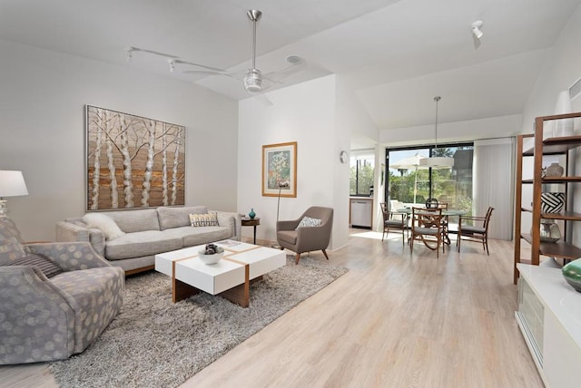 living room featuring ceiling fan, vaulted ceiling, track lighting, and light wood-type flooring