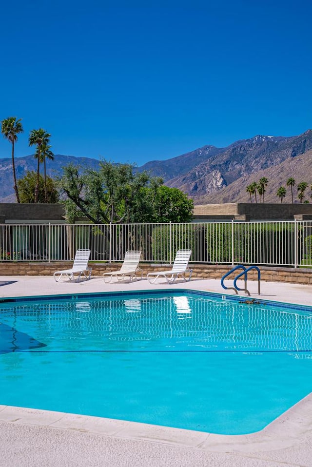 view of swimming pool featuring a mountain view