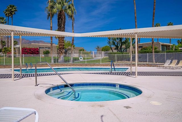 view of swimming pool with a community hot tub