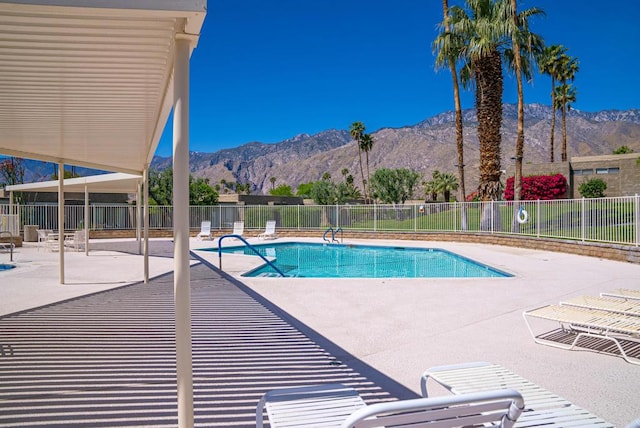 view of swimming pool featuring a mountain view and a patio area