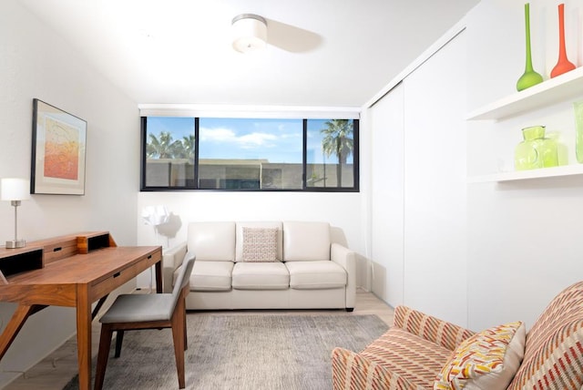 living room featuring ceiling fan and light hardwood / wood-style flooring