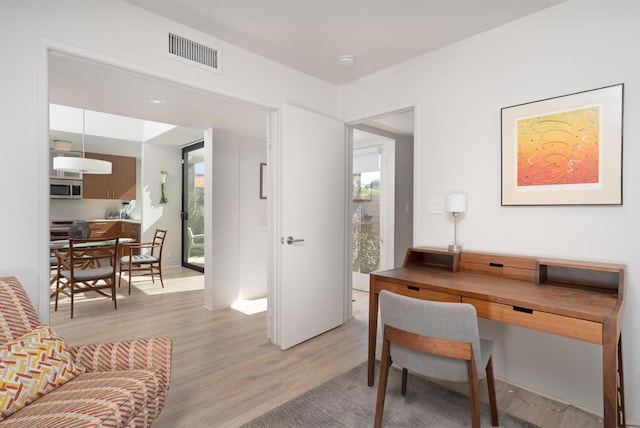 office with light hardwood / wood-style flooring