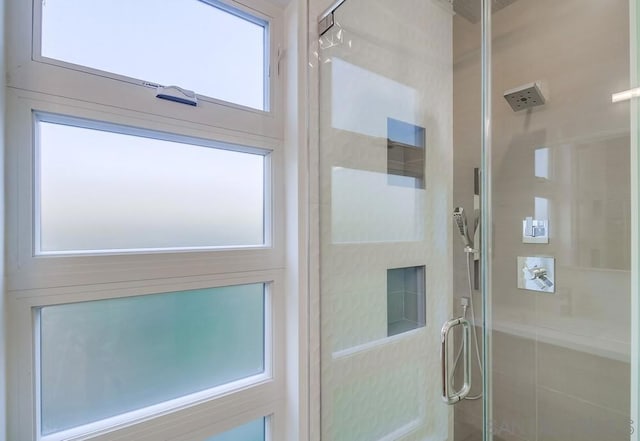 bathroom with a shower with door