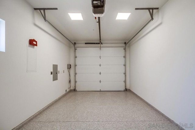 garage with electric panel and a garage door opener