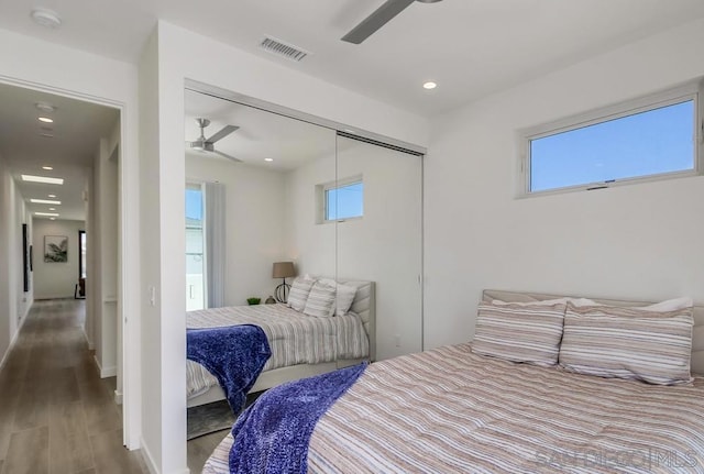 bedroom featuring ceiling fan, wood-type flooring, and a closet